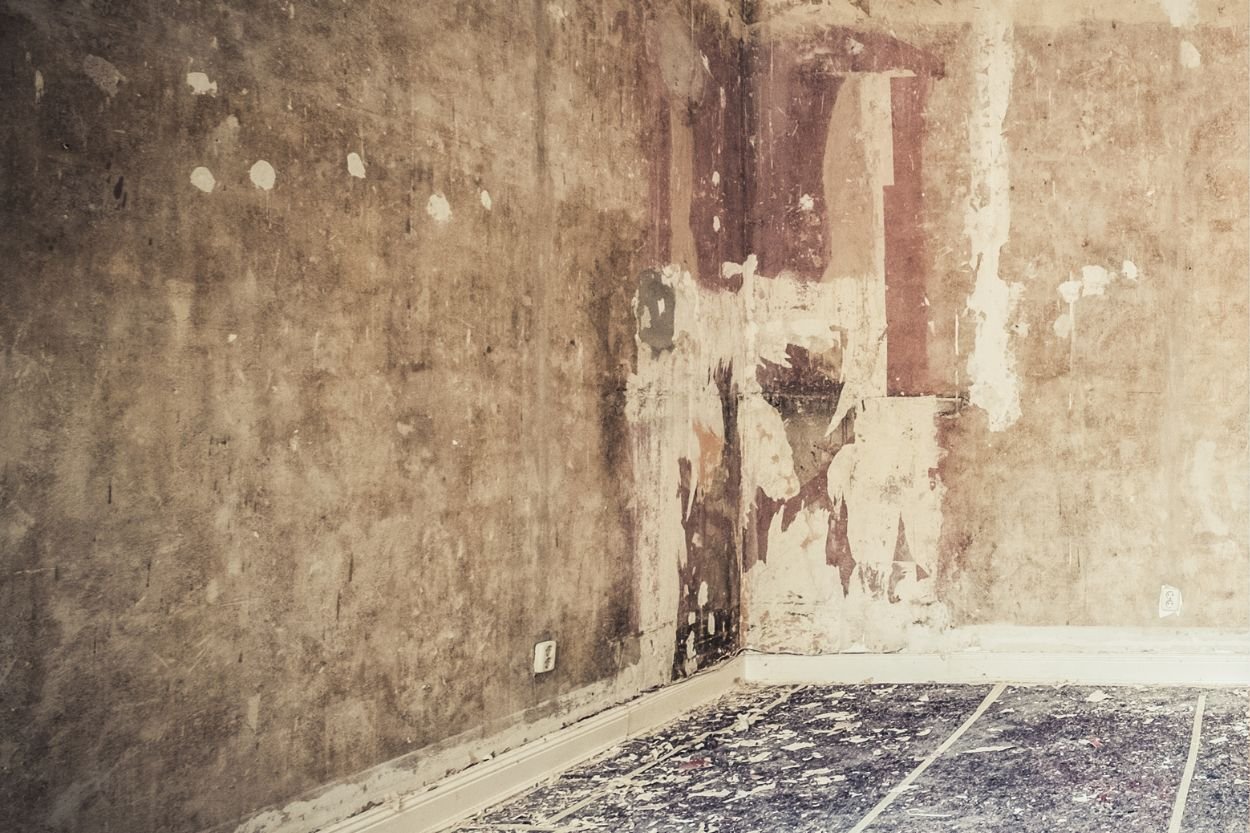 Empty basement room with a broken wall and floor, highlighting the need for mold removal services in Las Vegas, NV.